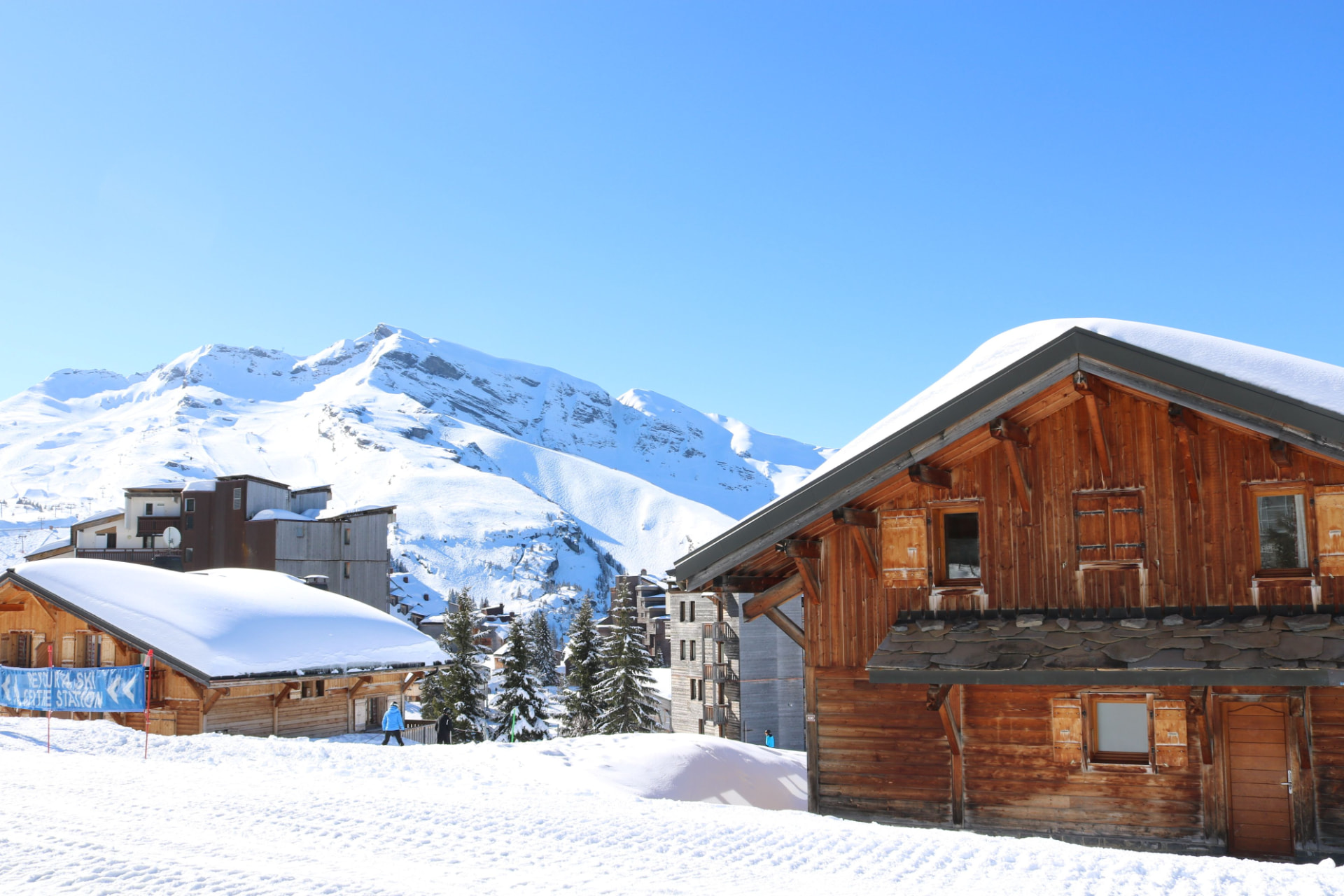 Besneeuwd wintersportdorp met houten chalets